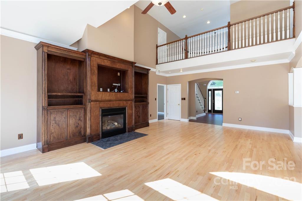 323 Ferguson Ridge Road Clover, SC 29710 - Photo 14 of 47 a view of an empty room with fire place and a kitchen