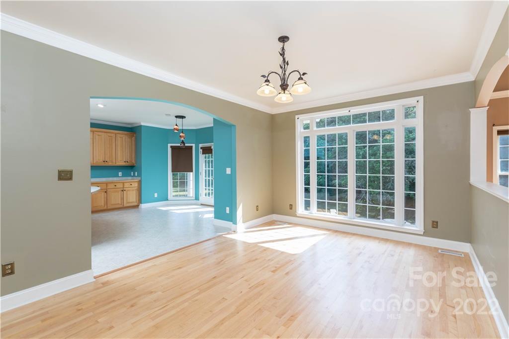 323 Ferguson Ridge Road Clover, SC 29710 - Photo 15 of 47 a view of an empty room with a window and wooden floor