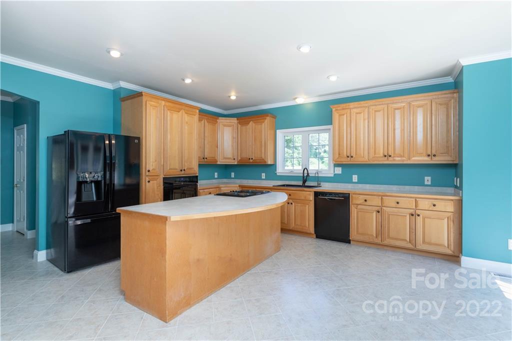 323 Ferguson Ridge Road Clover, SC 29710 - Photo 17 of 47 a large kitchen with stainless steel appliances granite countertop a refrigerator a sink a stove a microwave and island with wooden floor