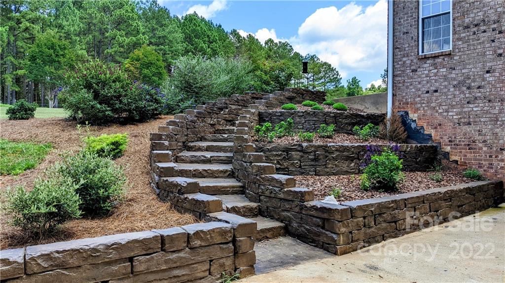 323 Ferguson Ridge Road Clover, SC 29710 - Photo 36 of 47 a garden with lots of trees and flowers