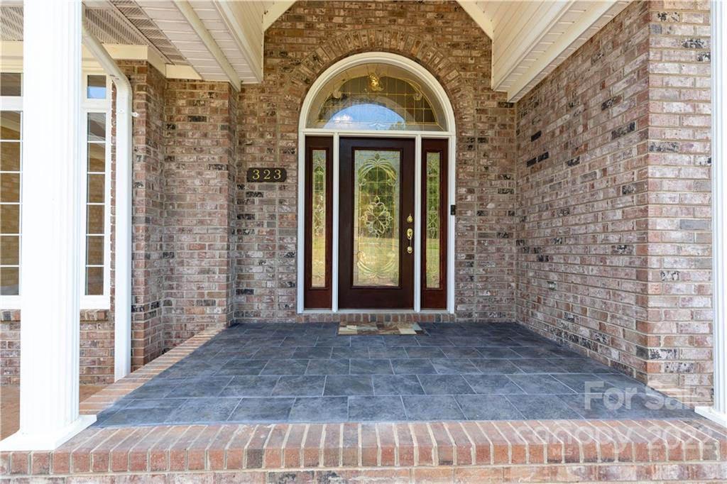 323 Ferguson Ridge Road Clover, SC 29710 - Photo 7 of 47 a view of a brick house with large windows