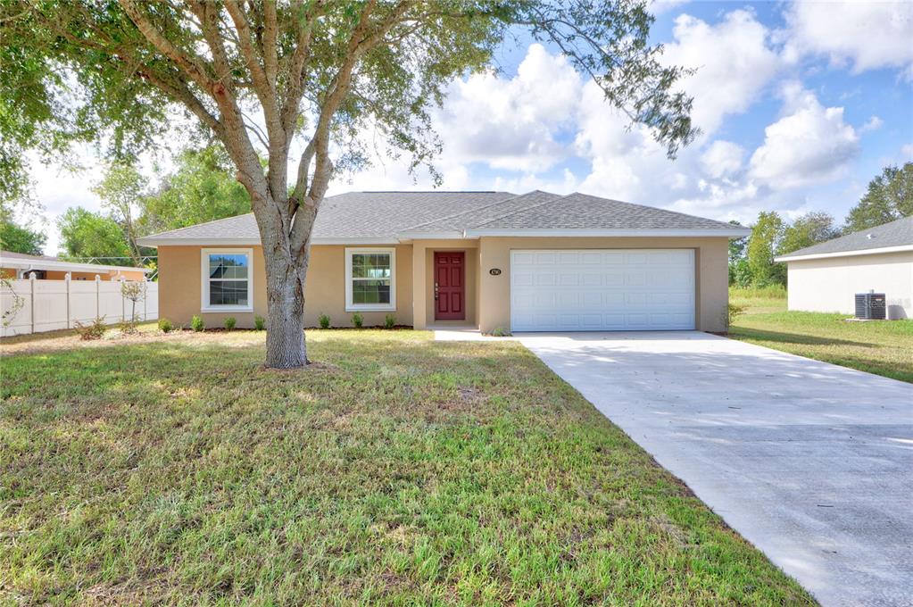 13056 60th Court Road Ocala, FL 34473 - Photo 1 of 1 a front view of house with yard and trees