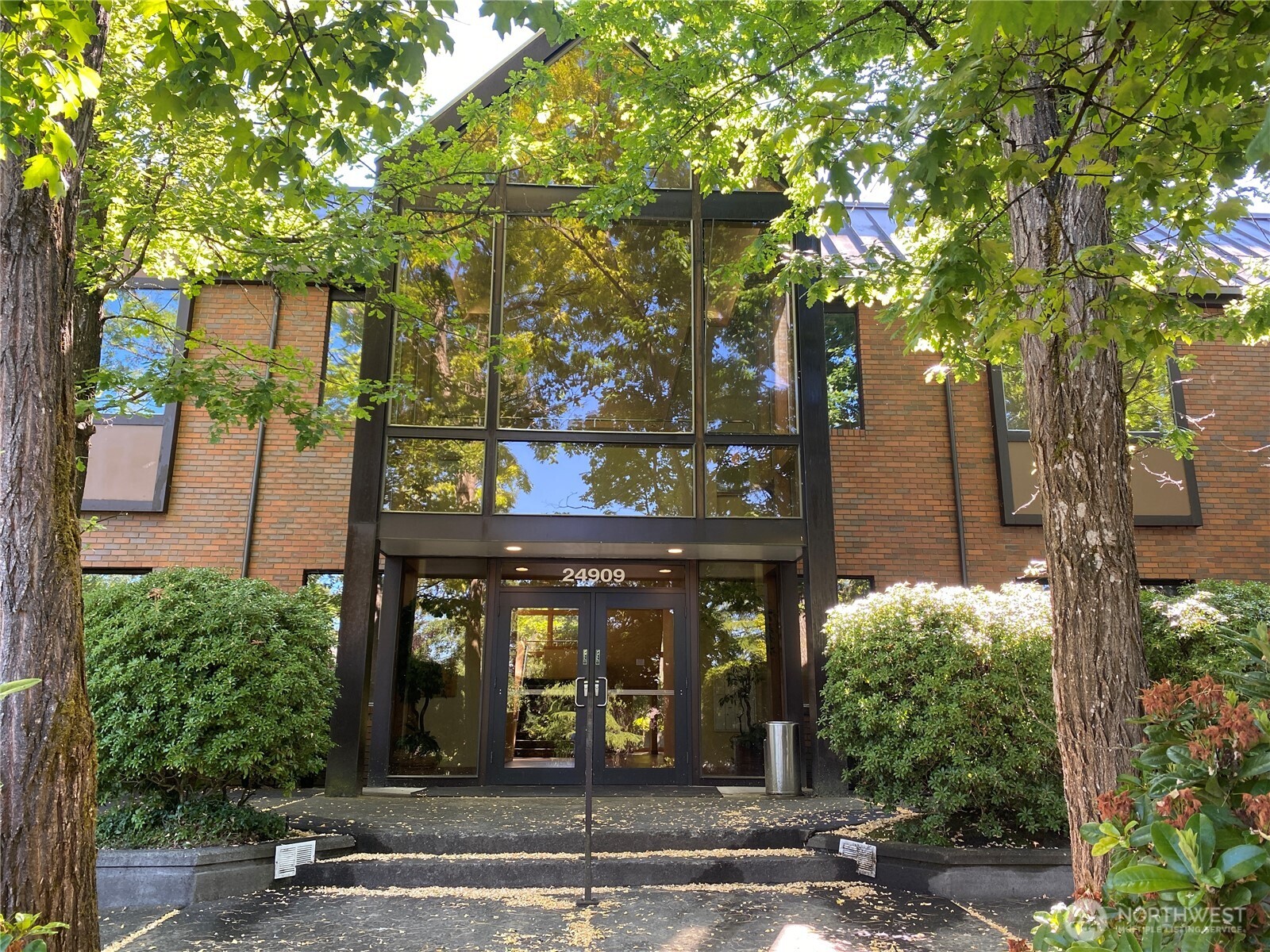 a front view of a building with tree s