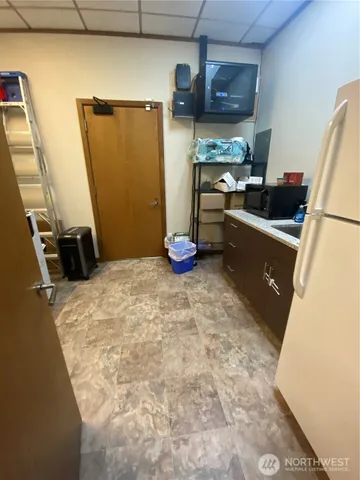 a kitchen with stainless steel appliances granite countertop a refrigerator a stove and a sink