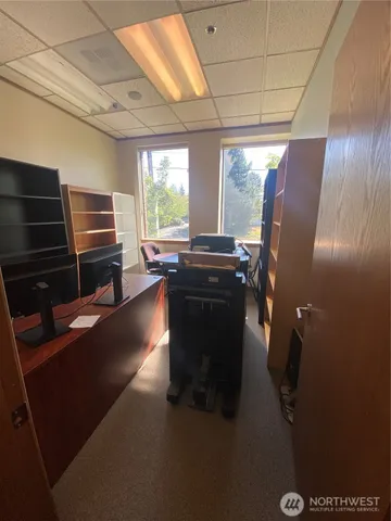 a room with wooden cabinets and stainless steel appliances