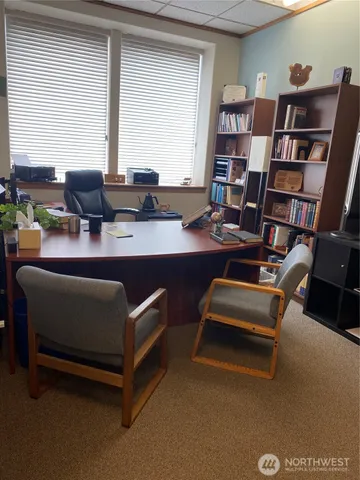a work room with furniture and a book shelf