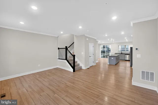 a view of empty room with wooden floor