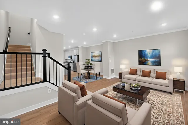 a living room with furniture or wooden floor and a flat screen tv