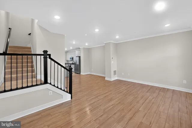 a view of a hallway with wooden floor