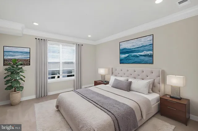 a bedroom with a large bed and a potted plant