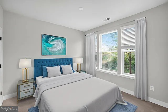 a bedroom with a large bed and a window