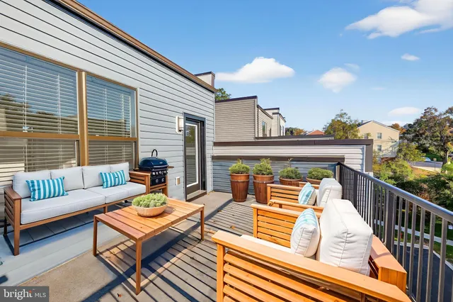 a view of a roof deck with furniture