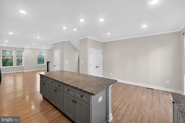 a bathroom with a granite countertop sink and a large mirror
