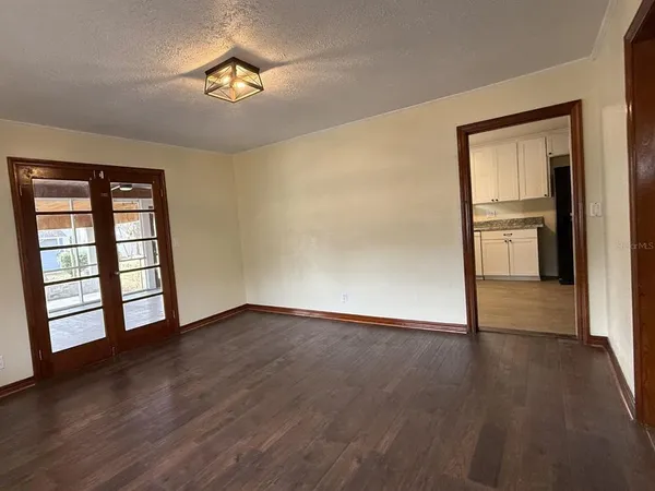 wooden floor in an empty room with a window