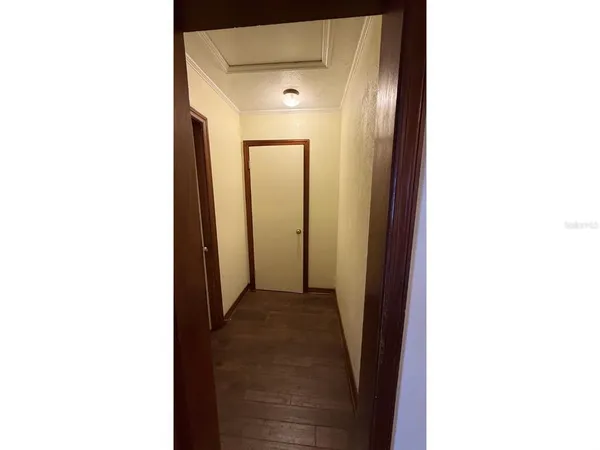 a view of a hallway with wooden floor