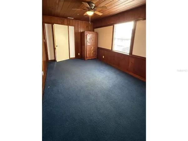 a view of room with window and a ceiling fan