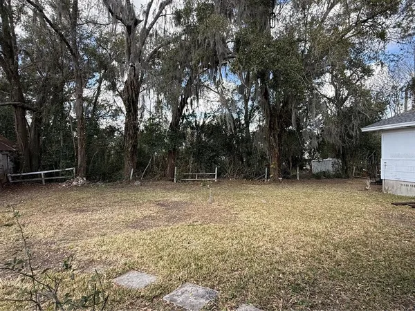a view of a house with a large window and brick house