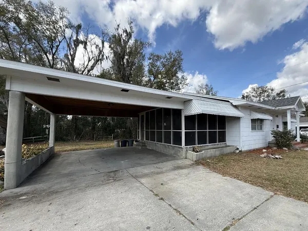 a view of a house with a yard and garage