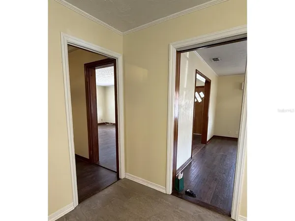 a view of a hallway with wooden floor