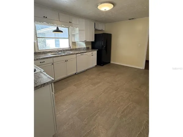 a kitchen with a sink cabinets and appliances