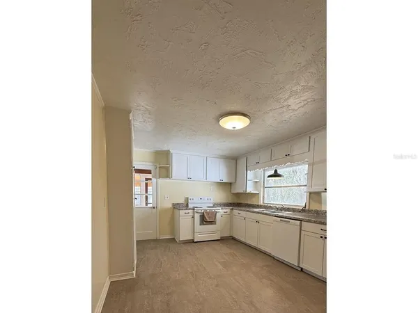 a kitchen with stainless steel appliances a refrigerator and a sink