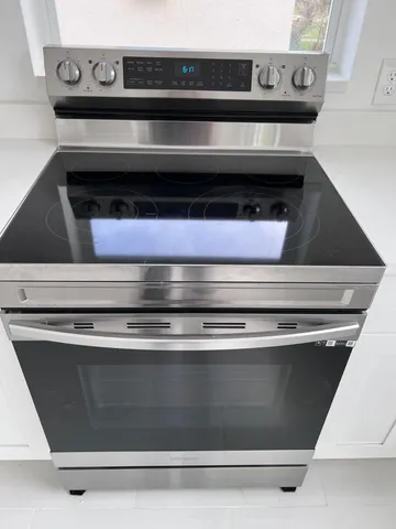 a stove top oven sitting inside of a kitchen