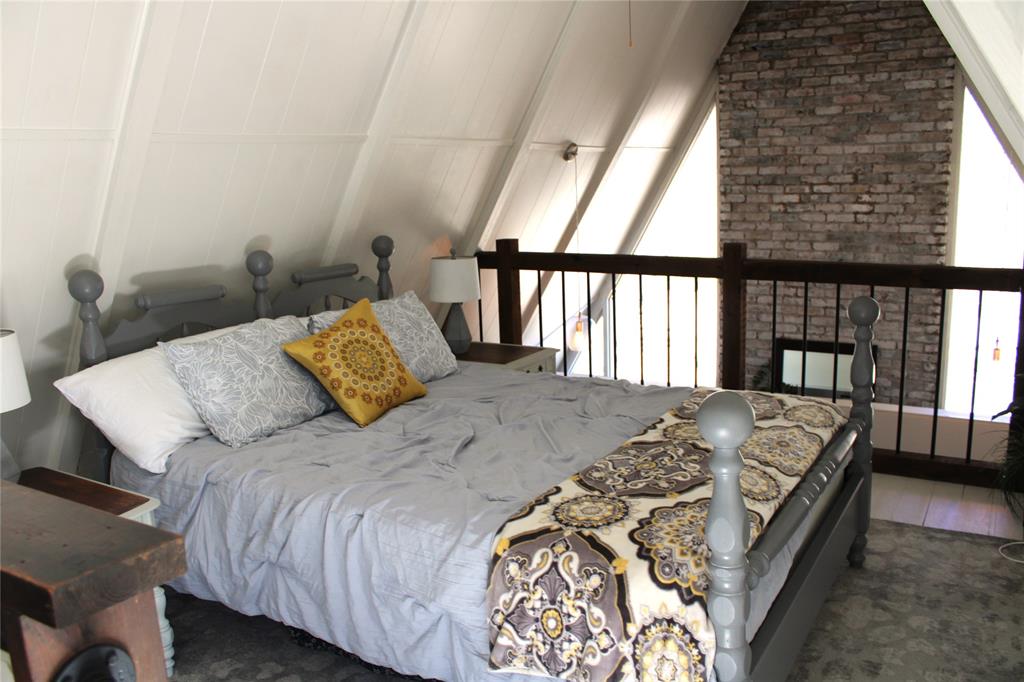 2629 Fox Point Road Quinlan, TX 75474 - Photo 19 of 30 a bed sitting in a bedroom next to a window