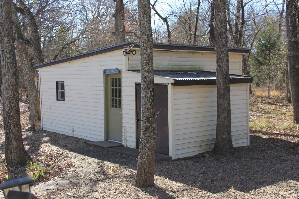 2629 Fox Point Road Quinlan, TX 75474 - Photo 24 of 30 a view of a house with a door and wooden fence