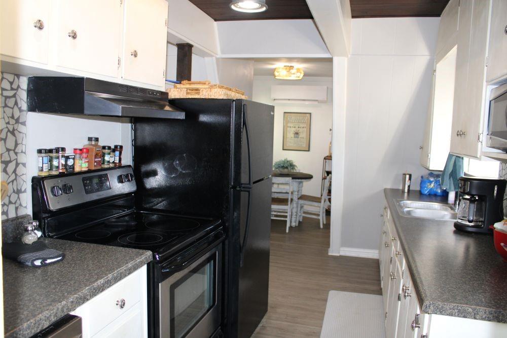 2629 Fox Point Road Quinlan, TX 75474 - Photo 9 of 30 a kitchen with granite countertop a stove and a refrigerator