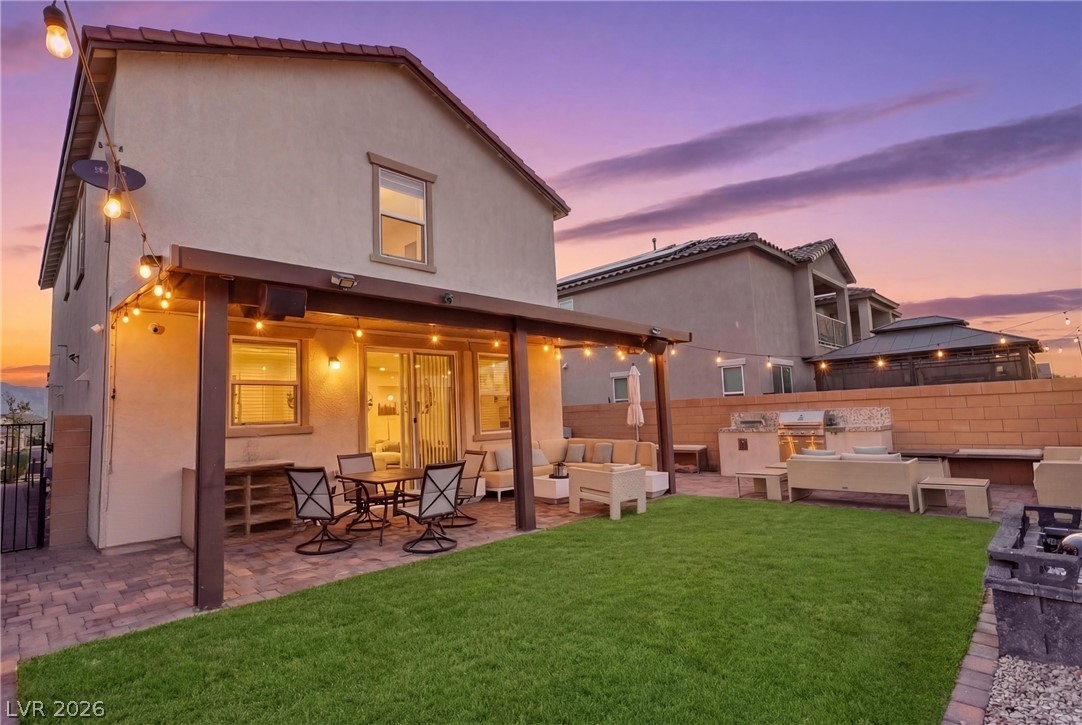 1921 Miller Ridge Avenue North Las Vegas, NV 89031 - Photo 22 of 26 This outdoor oasis offers a spacious patio, lush lawn, and outdoor kitchen, perfect for entertaining.