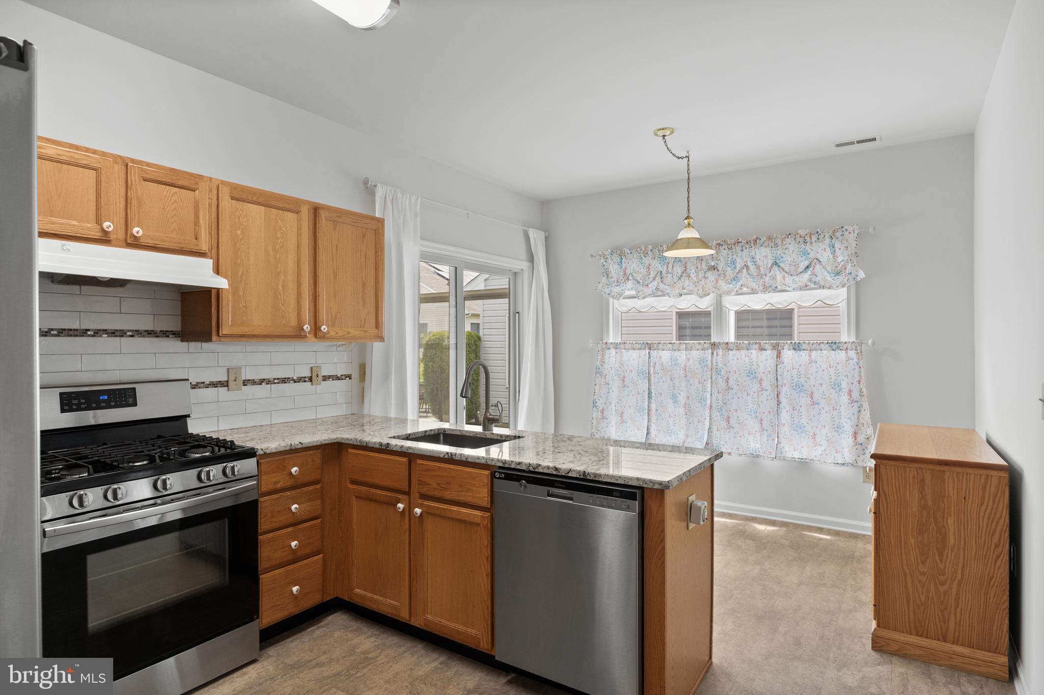 7 Covered Bridge Circle Columbus, NJ 08022 - Photo 14 of 40 a kitchen with granite countertop a sink stainless steel appliances and cabinets