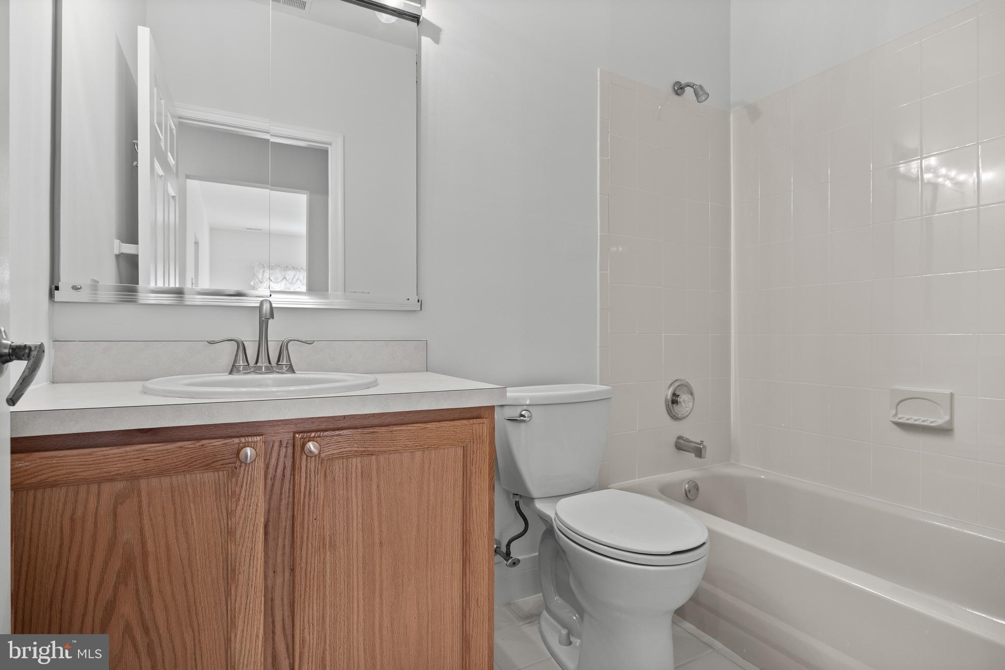 7 Covered Bridge Circle Columbus, NJ 08022 - Photo 23 of 40 a bathroom with a toilet a sink a mirror and bathtub