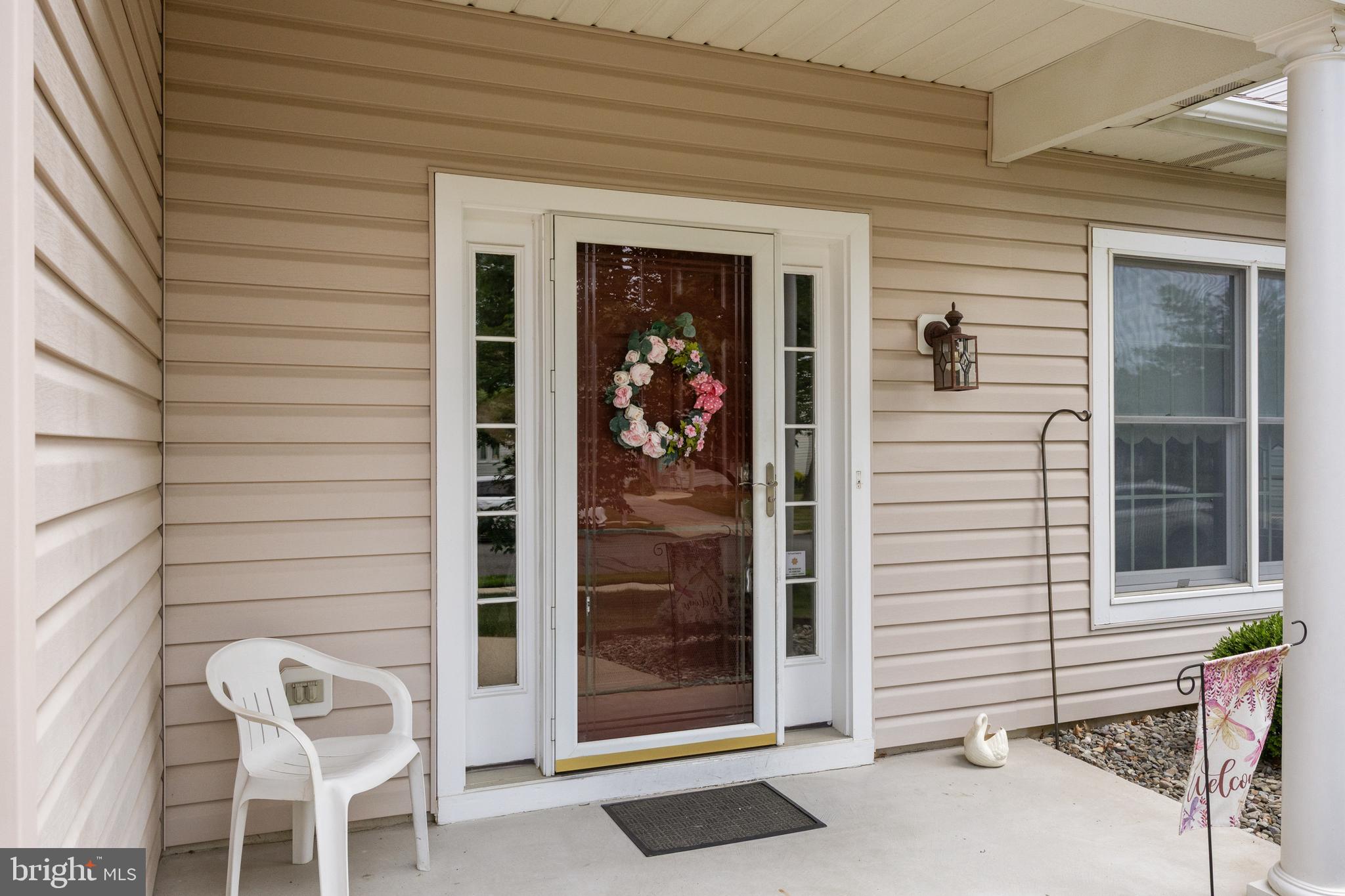 7 Covered Bridge Circle Columbus, NJ 08022 - Photo 4 of 40 a view of a porch with a table and chairs and potted plants