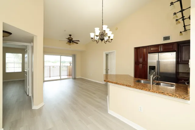 a view of a kitchen with granite countertop cabinets and a wooden floor