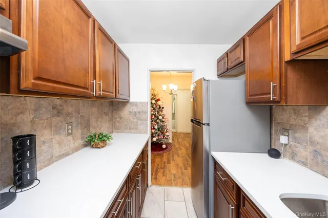 a kitchen with a sink a refrigerator and cabinets