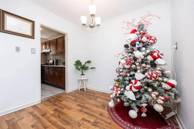 a flower room with a chandelier and kitchen view