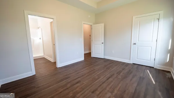 a view of a room with wooden floor and closet