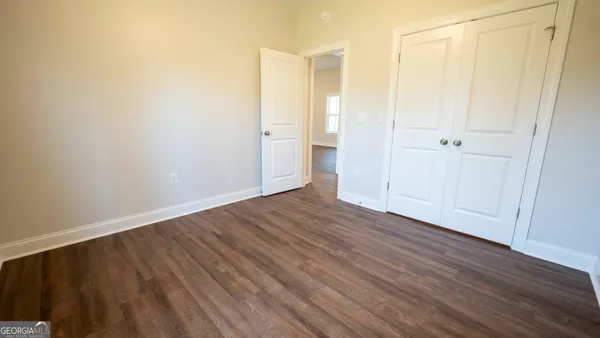 a view of a hallway with wooden floor