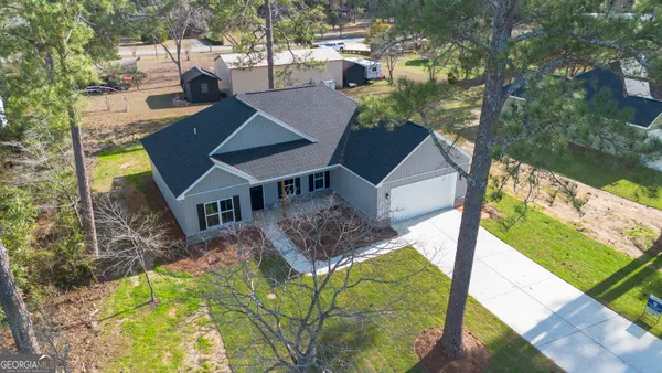 a front view of house with yard and green space