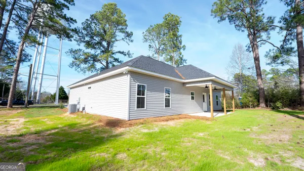 a view of backyard of house with trees