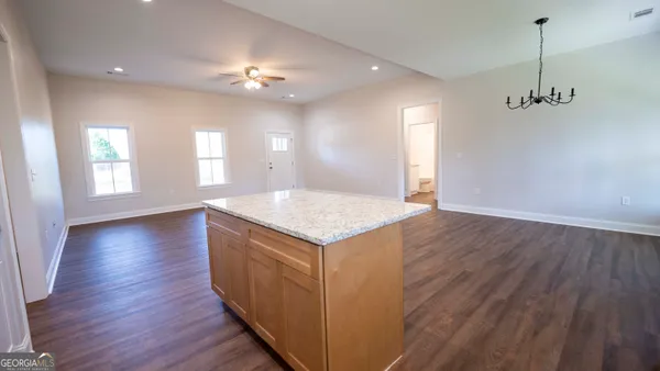 a view of a kitchen with a sink and chandelier