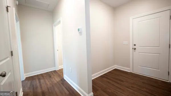 a view of a room with wooden floor