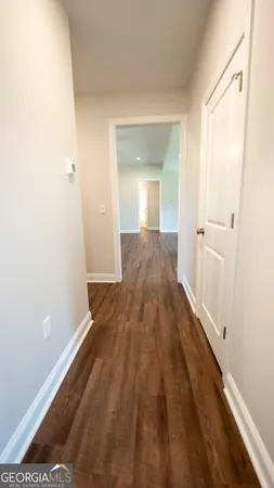 a view of a hallway with wooden floor