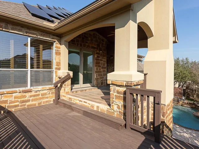 a view of a balcony with two chairs and wooden floor