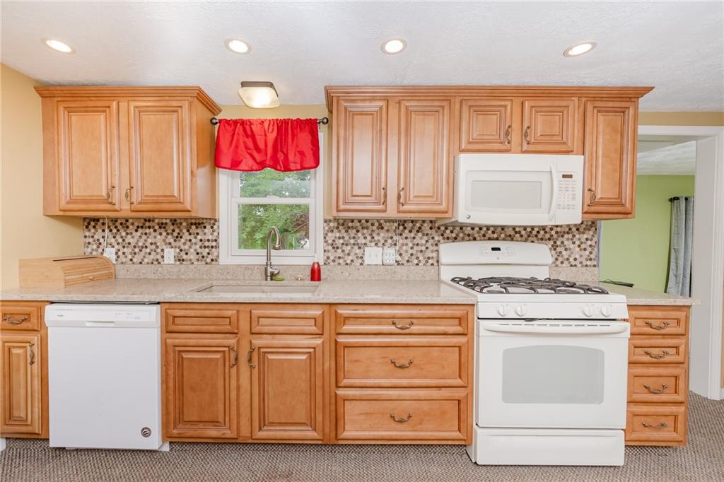 765 Main Street Rimersburg, PA 16248 - Photo 9 of 30 a kitchen with granite countertop a stove top oven sink and cabinets