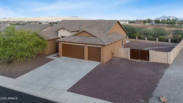 an aerial view of a house with a yard and garage