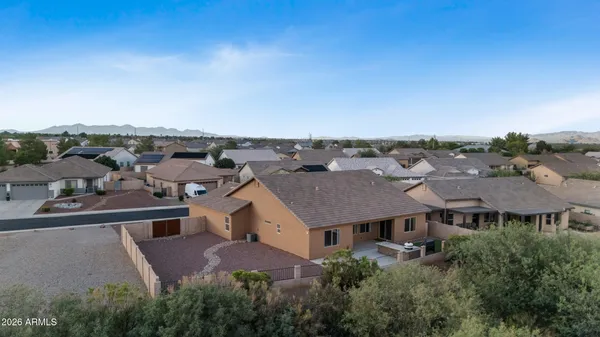 an aerial view of a house with a garden and mountain view