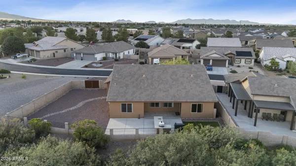 an aerial view of residential houses with outdoor space and trees