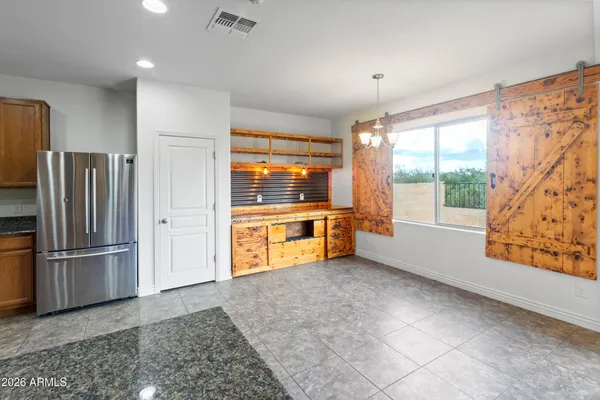 a kitchen with stainless steel appliances granite countertop a stove and cabinets