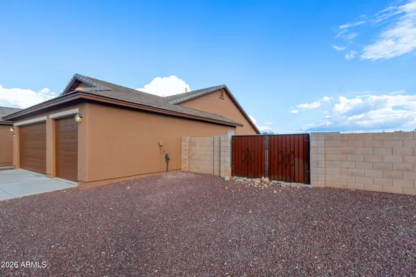 a view of a house with a backyard